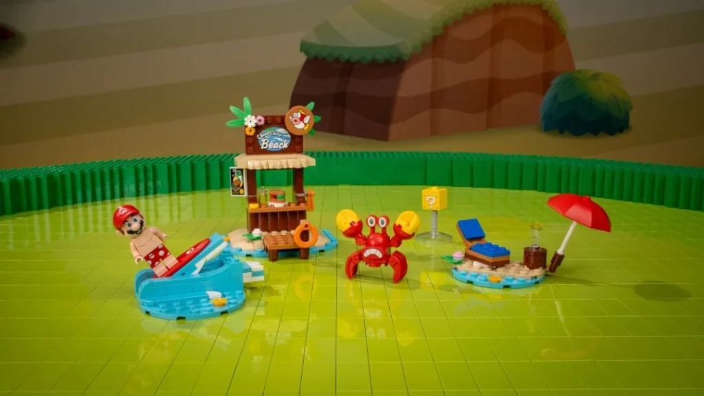 Minifigura do Mario numa prancha de surf, quiosque de praia, caranguejo vermelho e espreguiçadeira com guarda-sol em LEGO