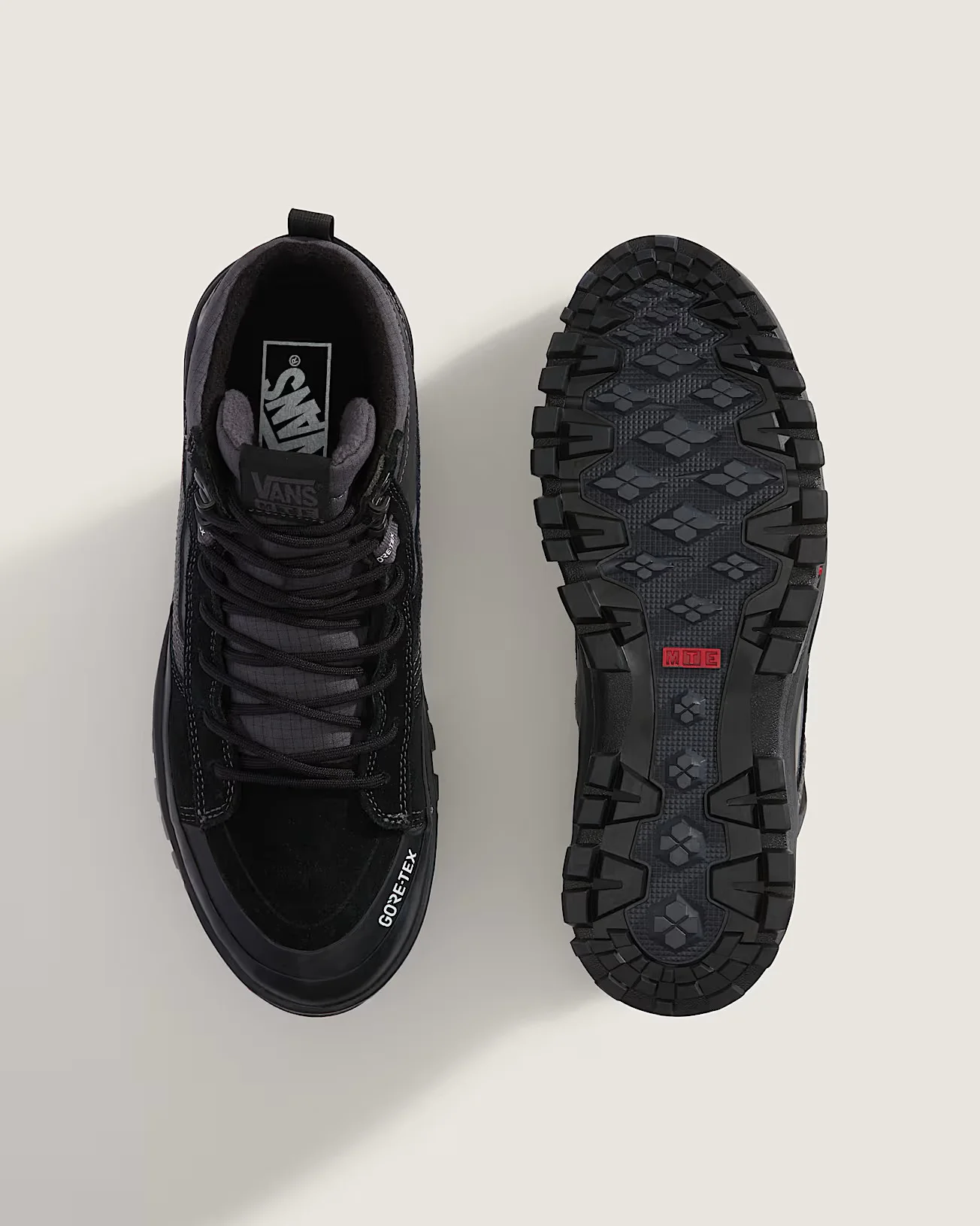 Par de botas de inverno para homem pretas Vans Sk8-Hi Gore-Tex mostrando o topo com atacadores e a sola tratorada MTE.