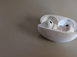 Auriculares sem fios brancos dentro da caixa de carregamento aberta.