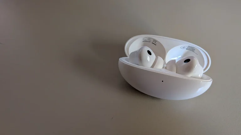 Auriculares sem fios brancos dentro da caixa de carregamento aberta.