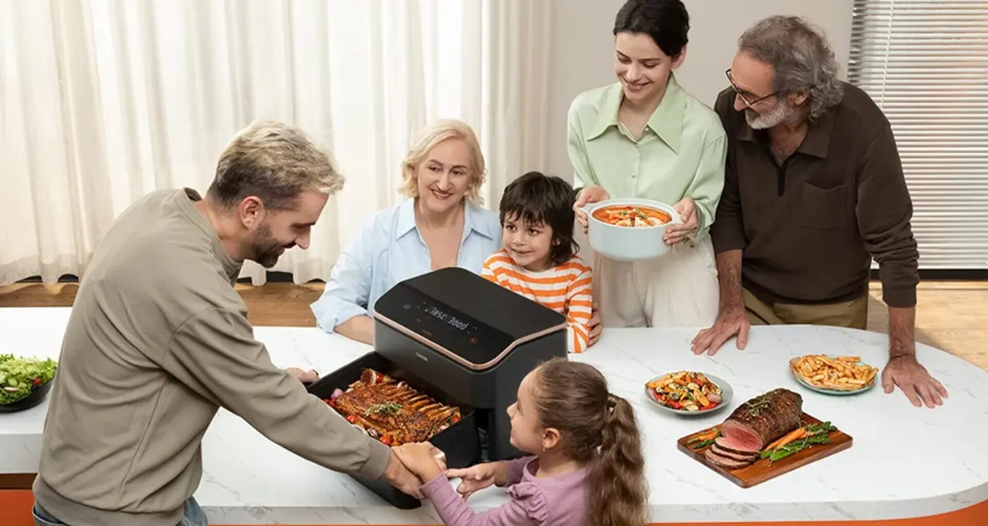 Família a preparar refeição com fritadeira elétrica.