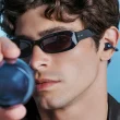 Homem com óculos de sol e auriculares azuis tecnológicos.
