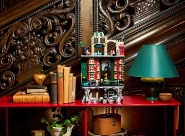 LEGO Ministério da Magia em prateleira vermelha com livros antigos.