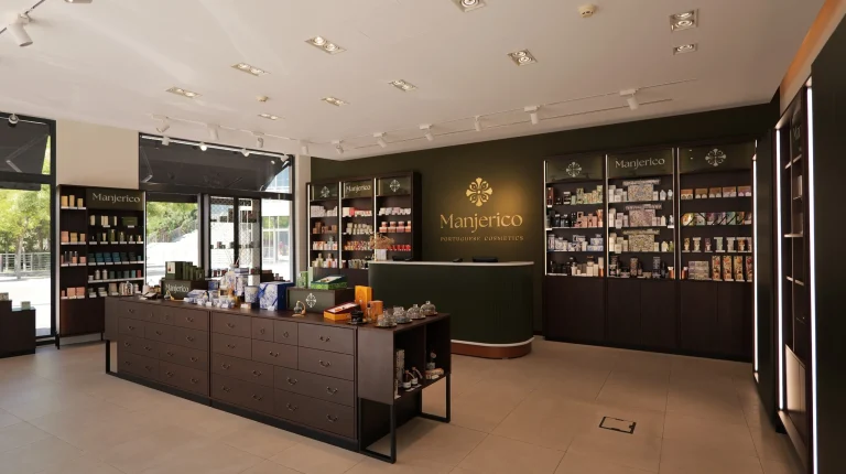Interior da loja Manjerico com expositores de cosméticos e balcão.