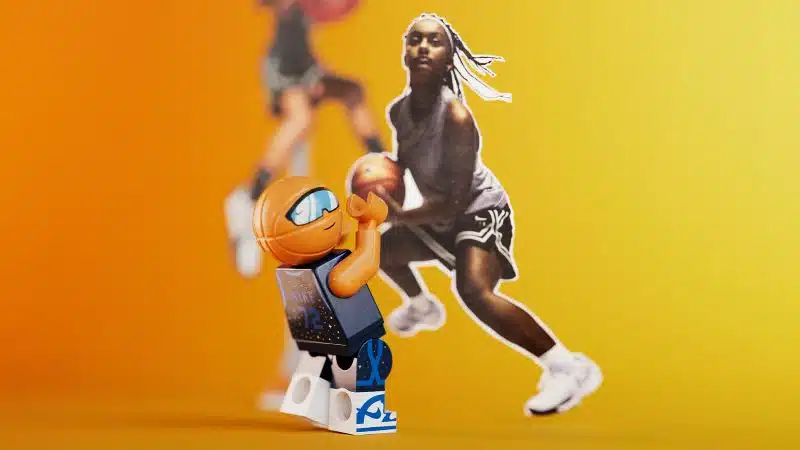 Boneco de brinquedo a jogar basquetebol com fundo amarelo.