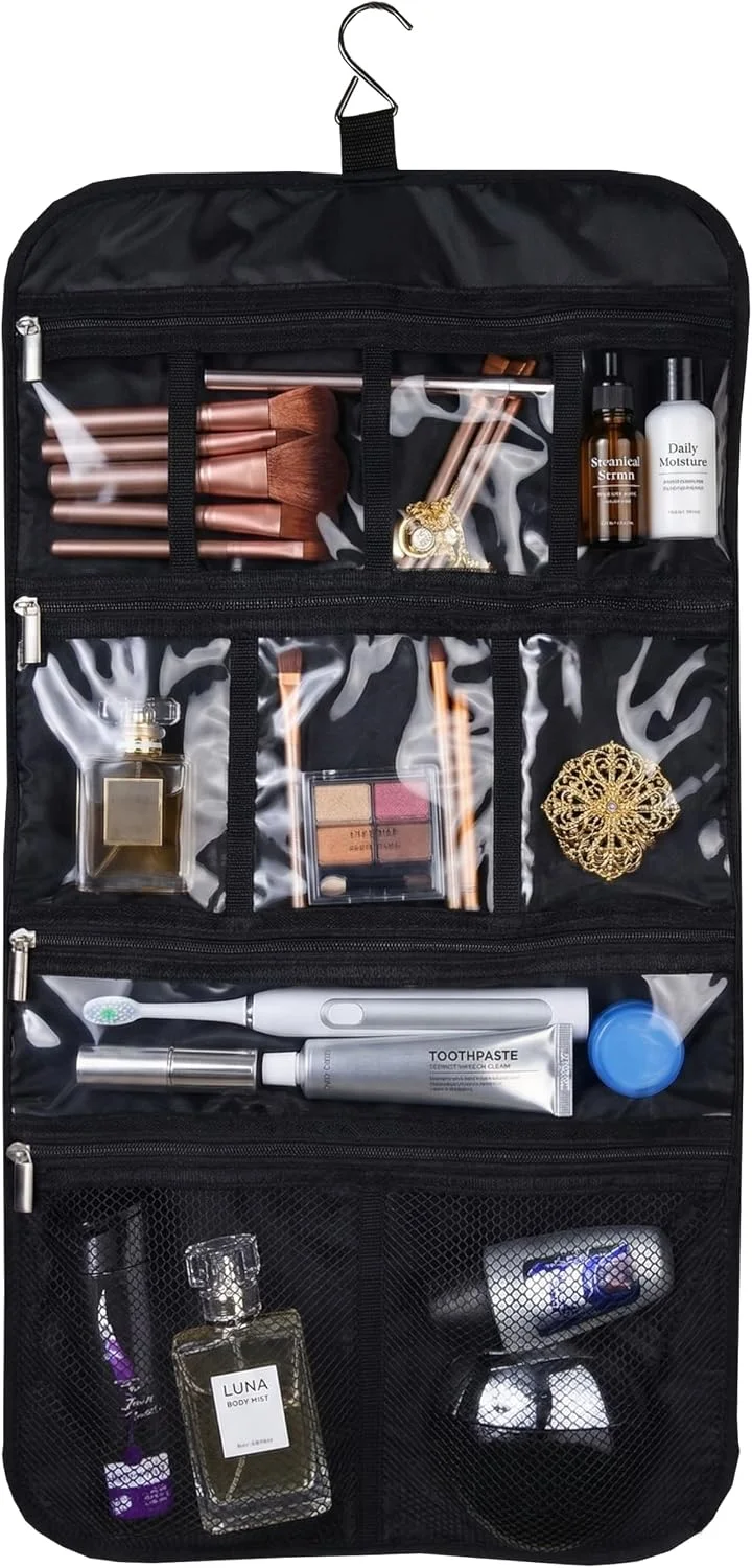 Necessaire de viagem preto aberto e suspenso por um gancho, com vários compartimentos transparentes e em rede contendo cosméticos, pincéis, escova de dentes elétrica e perfumes.