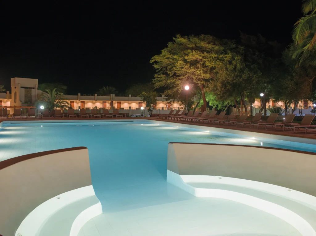 Piscina exterior de água salgada e espreguiçadeiras com vista panorâmica sobre o mar no Hotel Oasis Atlântico Praiamar na zona da Prainha na cidade da Praia em Santiago.