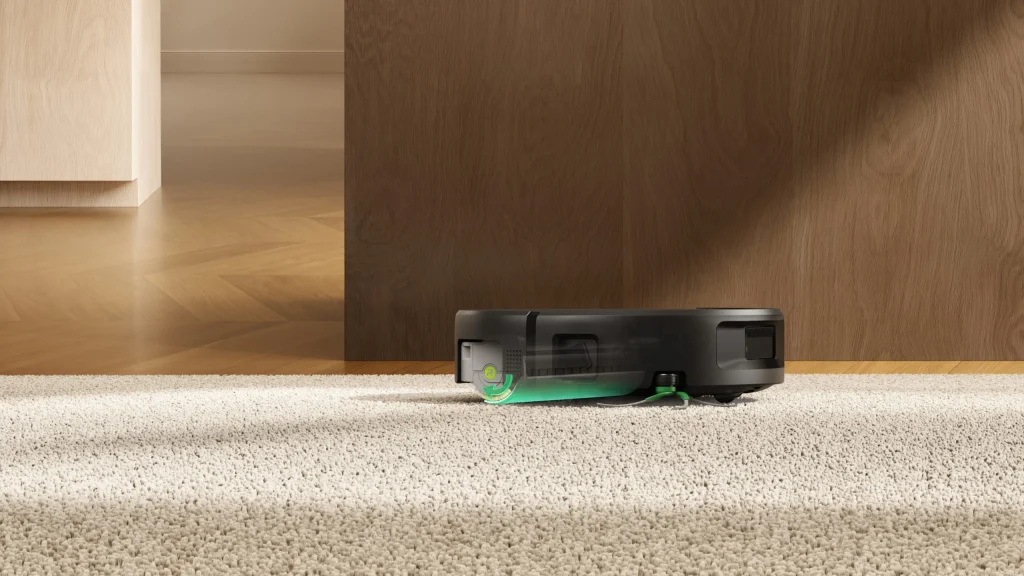 Aspirador robô Roomba Max 875 Combo sobre um tapete branco com vista gráfica transparente do mecanismo interno do rolo