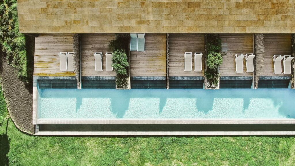 Piscina moderna com espreguiçadeiras de madeira