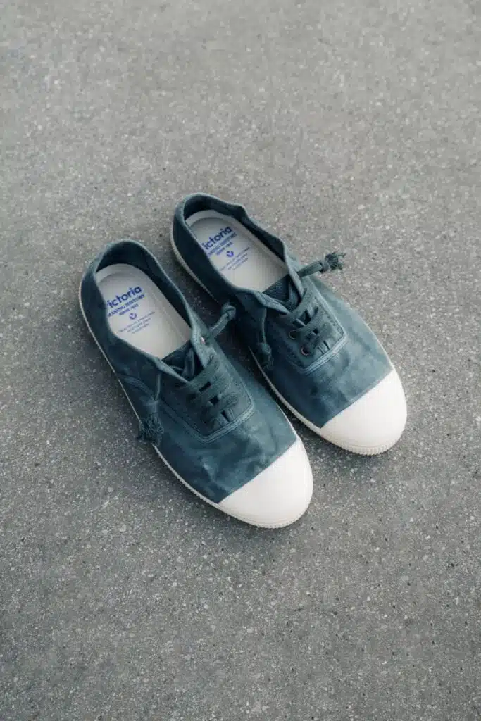 Sapatilhas azul e branco no chão cinzento